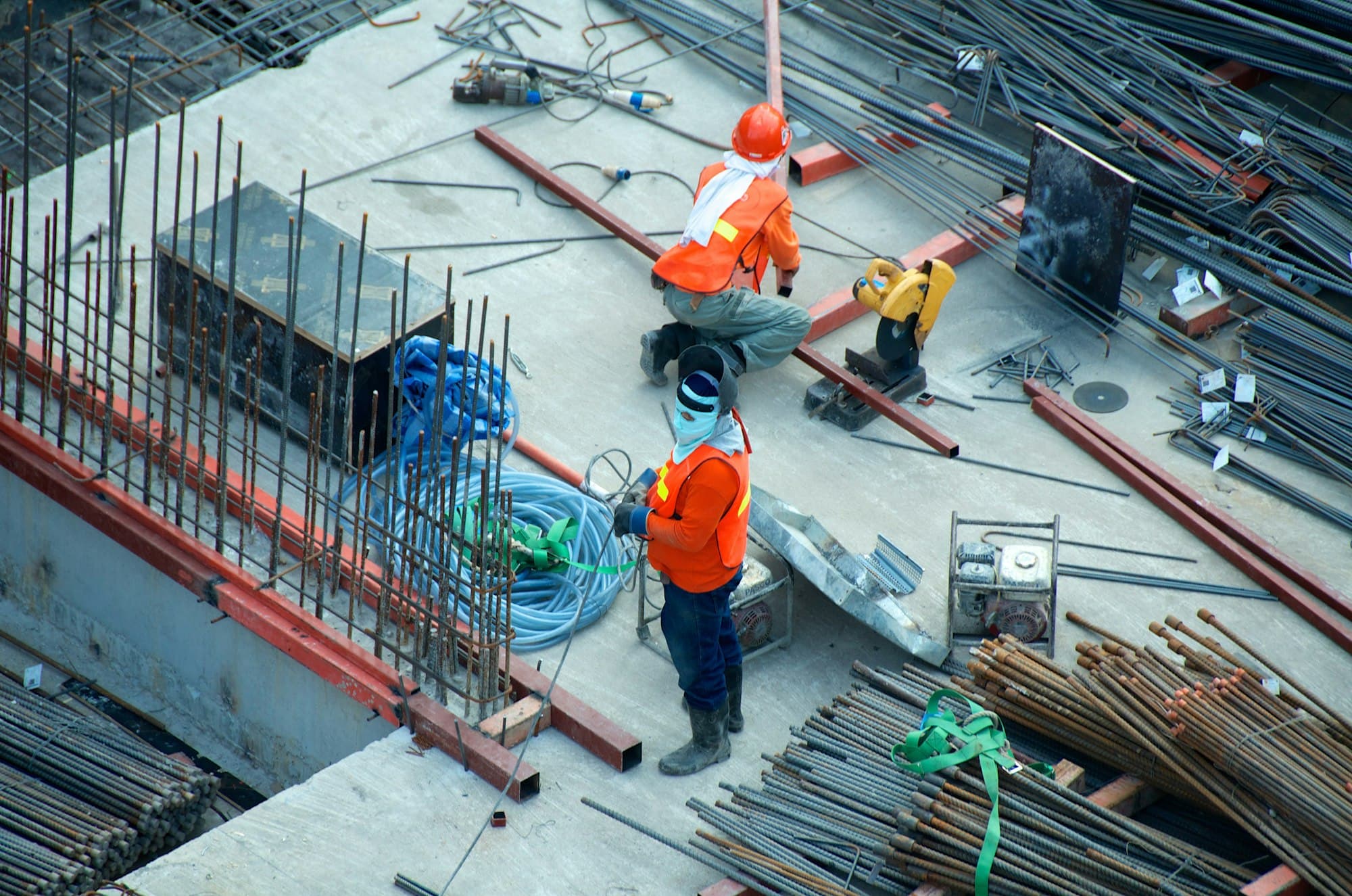 Construction workers in high-visibility PPE on an active site